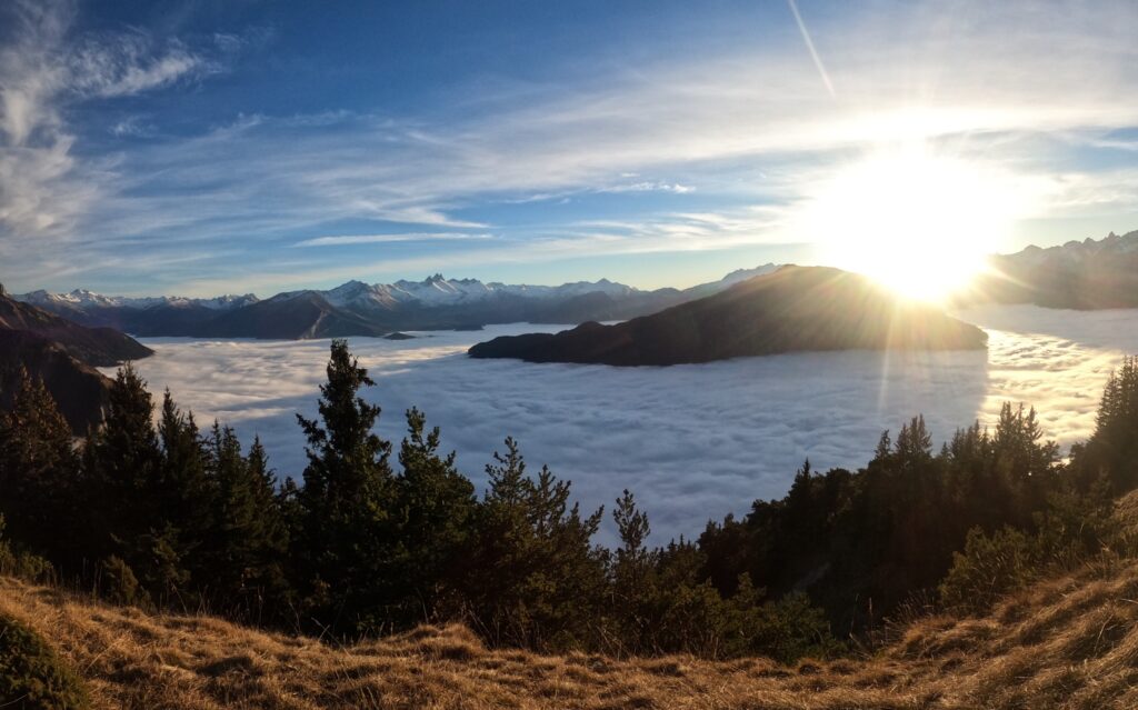 Panorama from Croix de la Chal towards La Tour en Maurienne, with a sea of clouds in front of a sunset