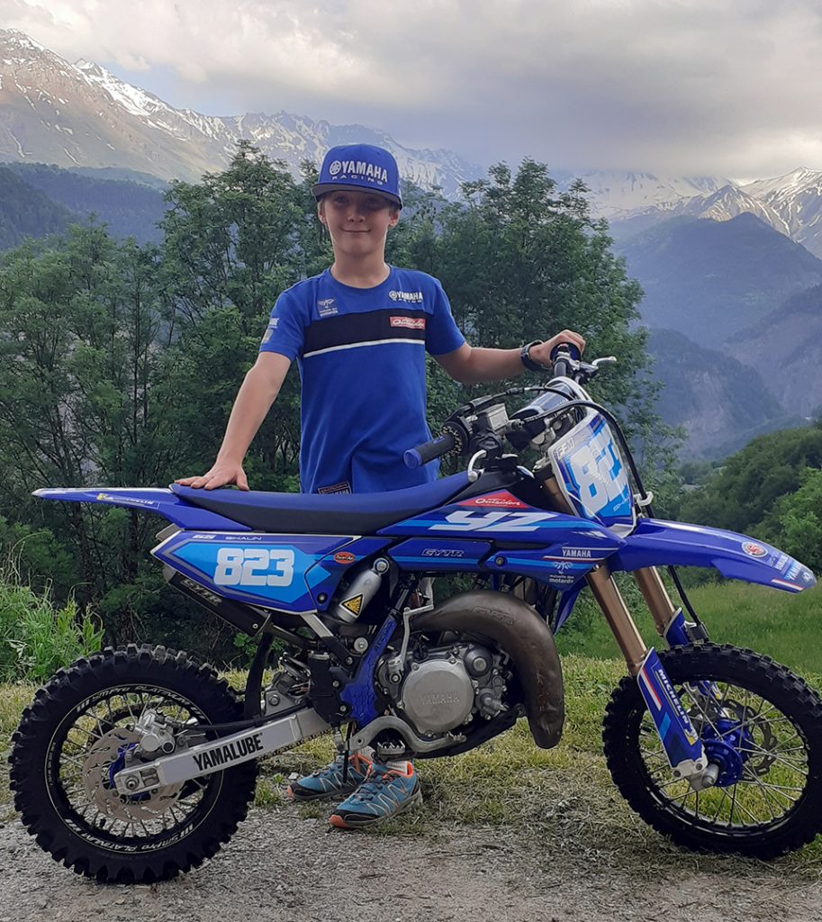 Profile picture of Shaun Binet, showing off his motorcycle in front of a landscape