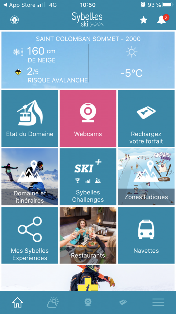 Copie d'écran de l'application Sybelles.ski qui renseigne sur les infos neige, l'état du domaine, les zones ludiques, les navettes et restaurants accessibles sur les pistes. l'appli permet également de recharger son forfait de ski et de participer à des jeux et challenges