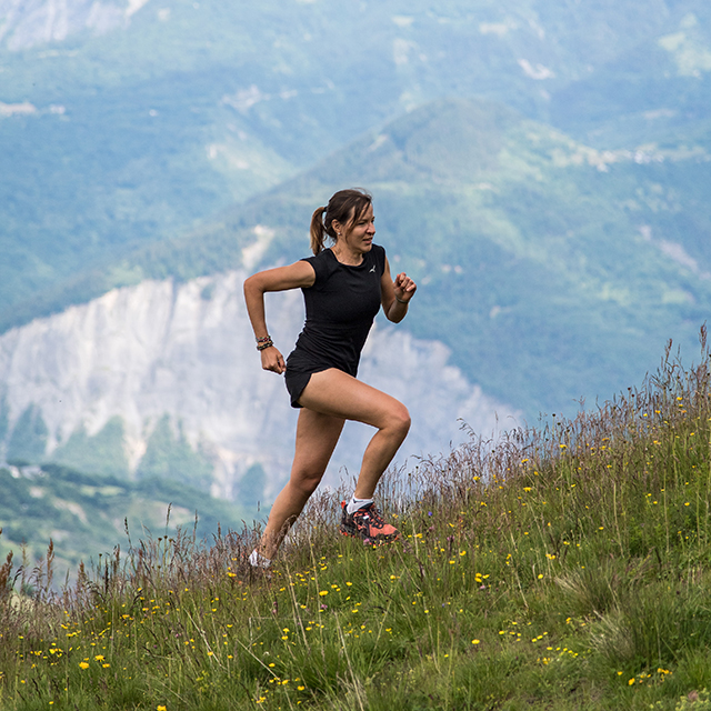 A trail runner trains on a slope in La Toussuire in summer.